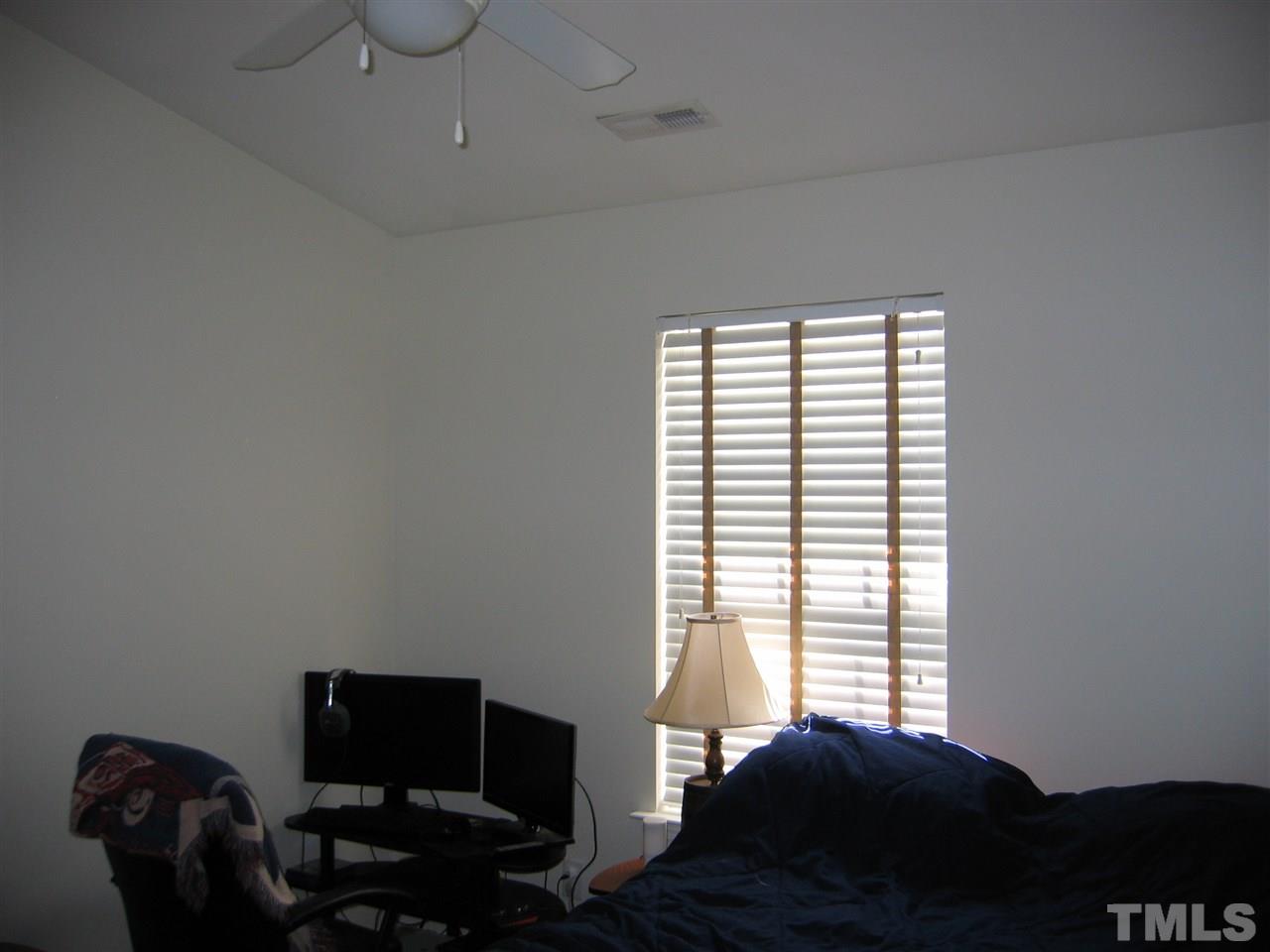2840 Barrymore Street, Unit 105 Raleigh, NC 27603 - Photo 8 of 9 a bedroom with a bed and a window