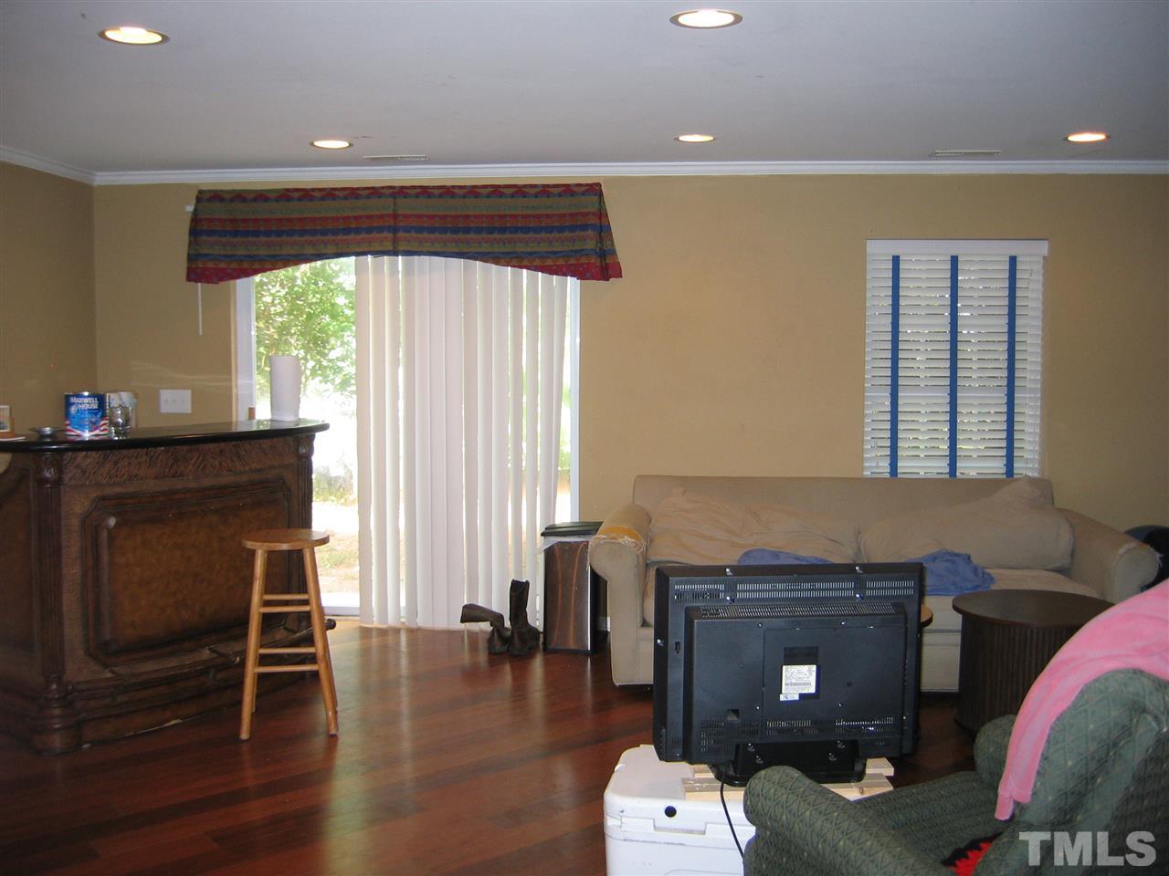 2840 Barrymore Street, Unit 105 Raleigh, NC 27603 - Photo 9 of 9 a living room with furniture and a wooden floor