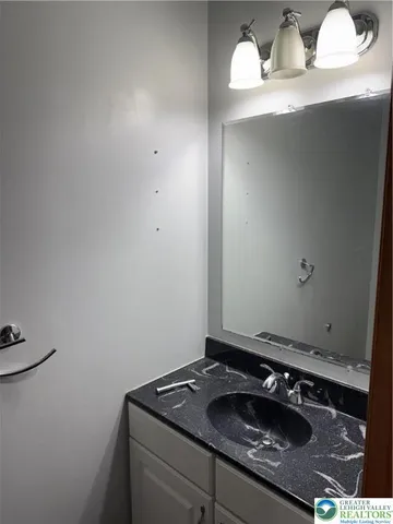 a bathroom with a sink and vanity