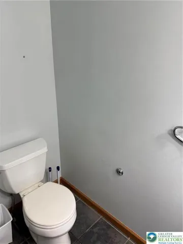 a white toilet sitting next to a shower