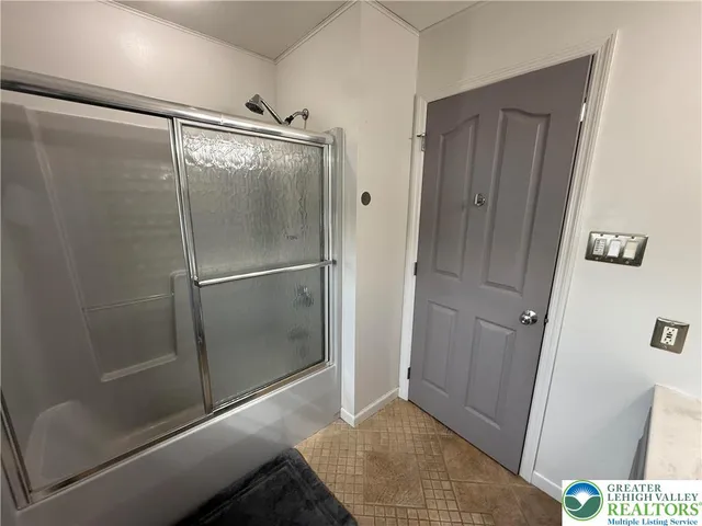 a bathroom with a shower and a sink