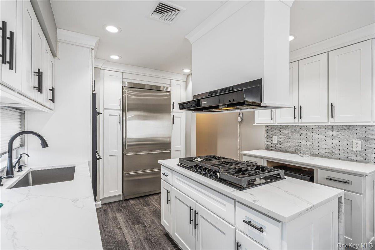 154-43 Riverside Drive Queens, NY 11357 - Photo 19 of 41 a kitchen with a stove and a refrigerator