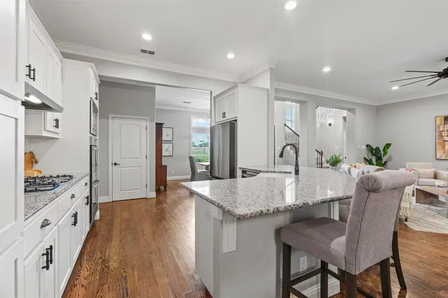a kitchen with granite countertop a table and chairs in it