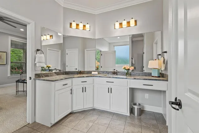 a spacious bathroom with a granite countertop sink mirror and a