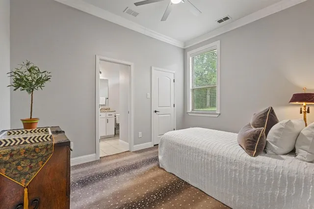 a bedroom with a bed and a potted plant