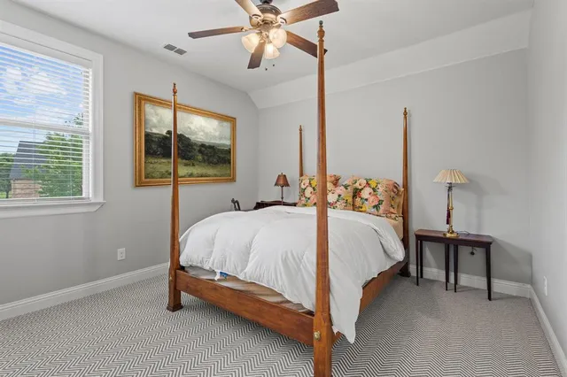 a bed sitting in a bedroom next to a window