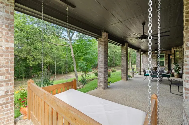 a view of a patio with a table chairs and a backyard
