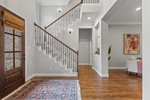 a view of entryway and hall with wooden floor