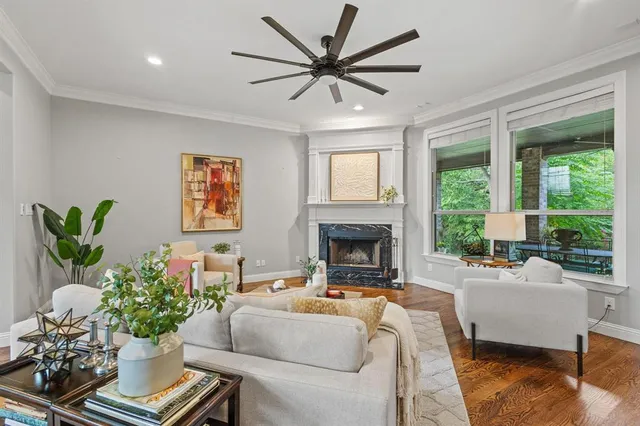 a living room with furniture fireplace and a large window