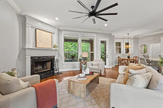 a living room with furniture a large window and a fireplace