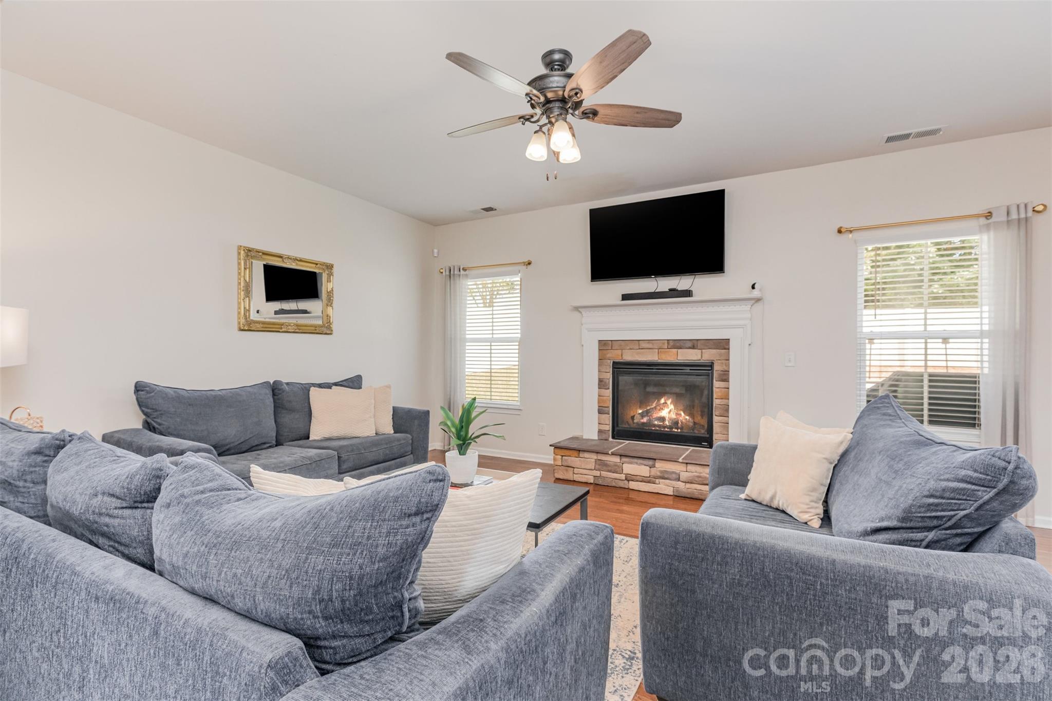 353 Chorus Road Fort Mill, SC 29715 - Photo 17 of 30 a living room with furniture a flat screen tv and a fireplace