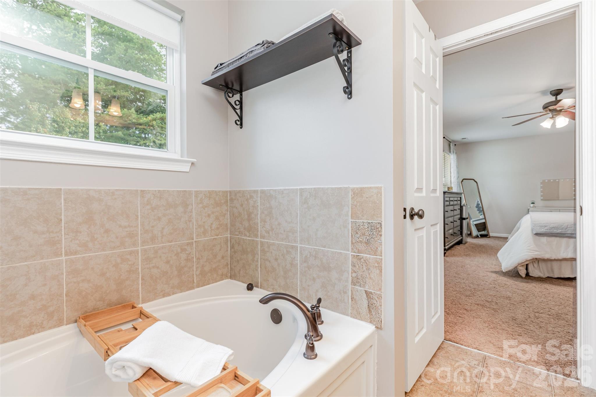 353 Chorus Road Fort Mill, SC 29715 - Photo 24 of 30 a bathroom with a tub and a window