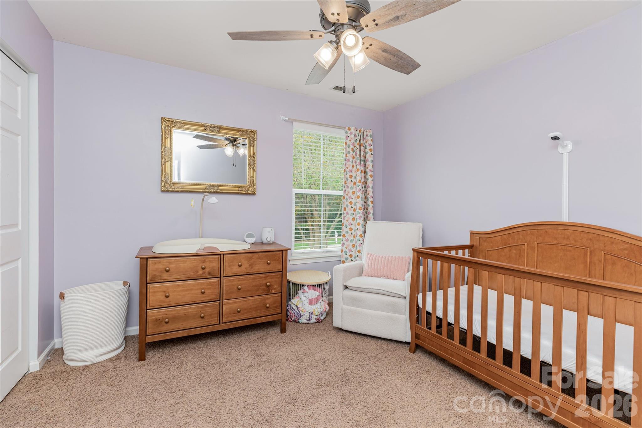 353 Chorus Road Fort Mill, SC 29715 - Photo 25 of 30 a bedroom with a bed and a chandelier