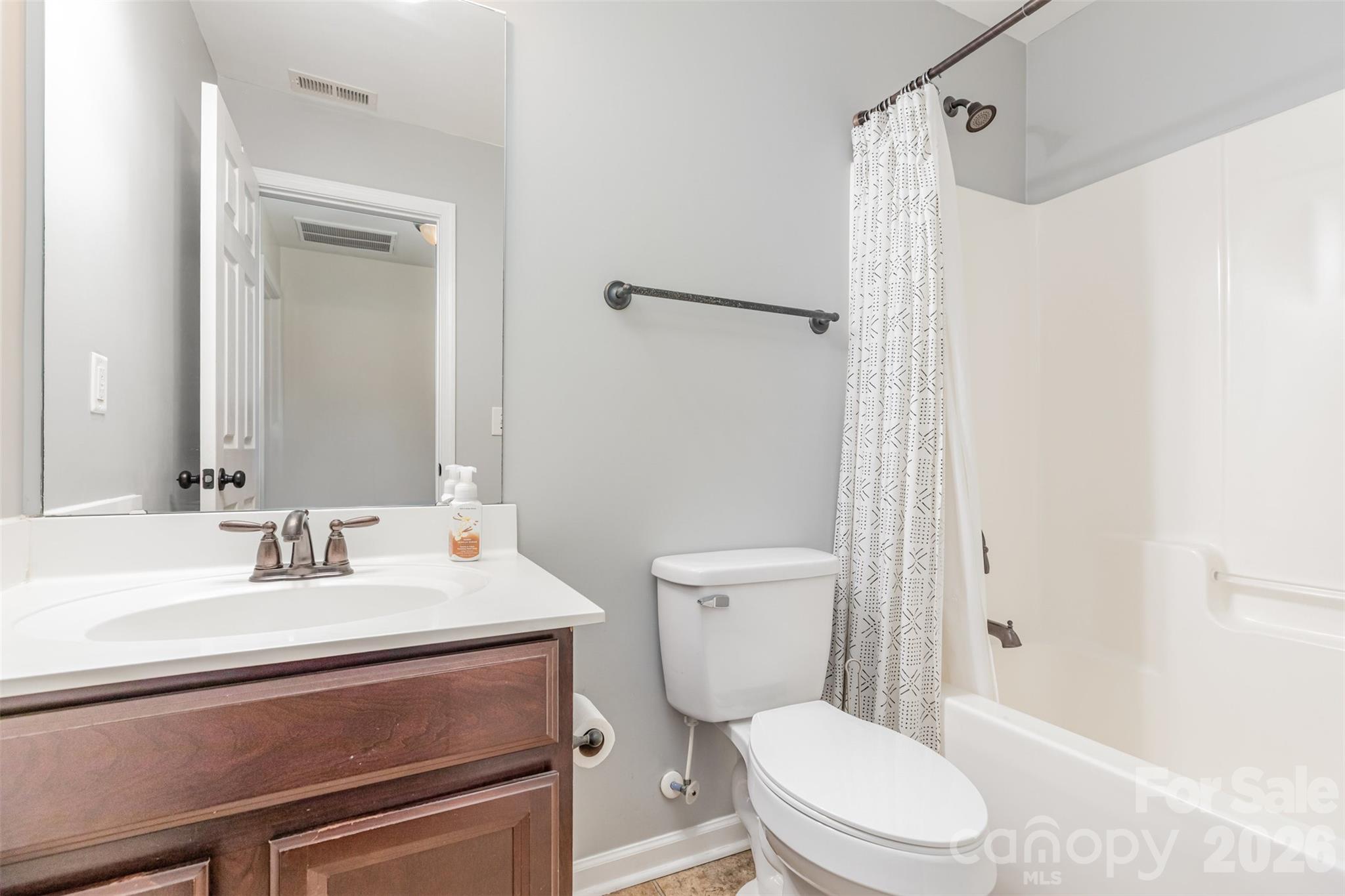 353 Chorus Road Fort Mill, SC 29715 - Photo 27 of 30 a bathroom with a sink a toilet a shower and a mirror