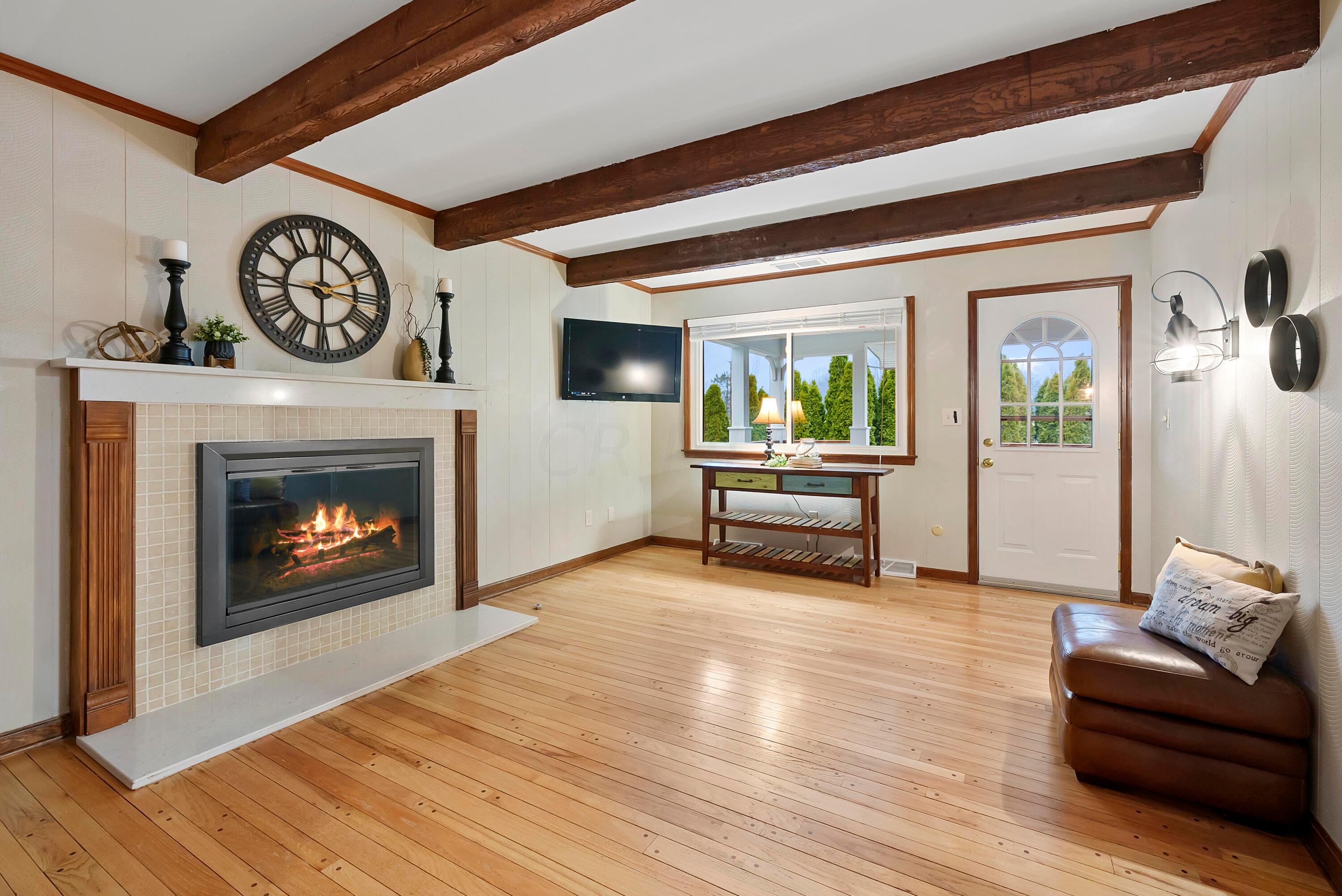 3174 Rome Corners Road Galena, OH 43021 - Photo 7 of 33 Gas Log Fireplace and Peg hardwood floors and exit to the Deck