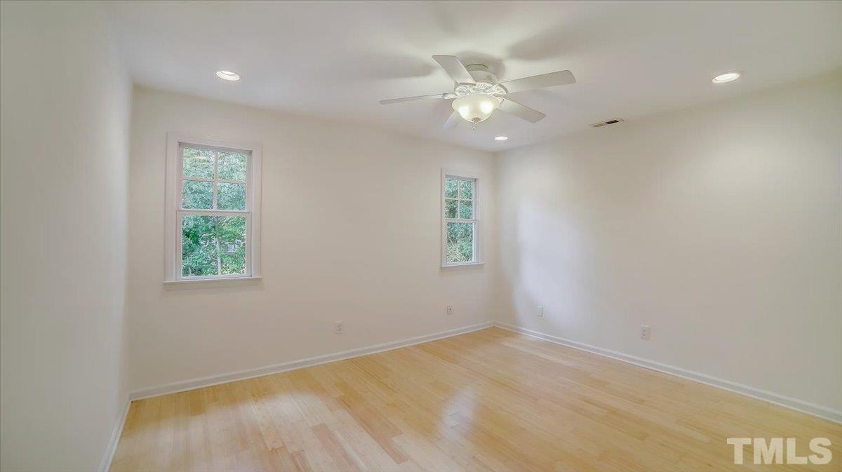 2504 Noble Road Raleigh, NC 27608 - Photo 13 of 28 an empty room with windows and fan