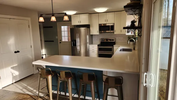 a kitchen with a sink cabinets and refrigerator