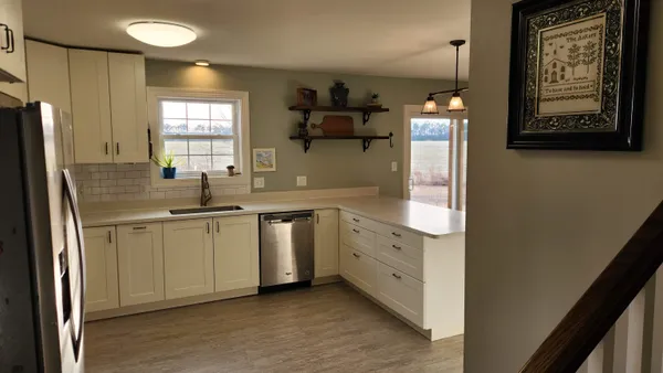 a view of a kitchen with a sink and wooden floor