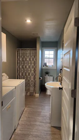 a bedroom with a bed and a flat tv screen on the dresser