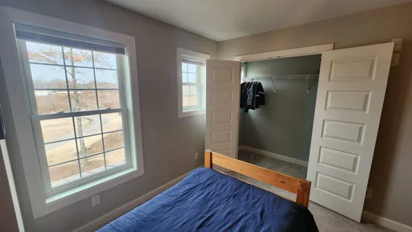 a bed room with a bed and a window