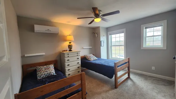 a bedroom with furniture and a baby crib