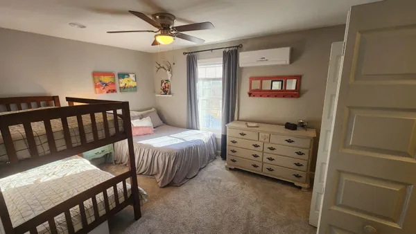 a bedroom with a bed and a chandelier