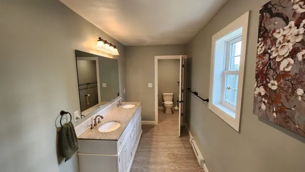 a white toilet sitting next to a white wall