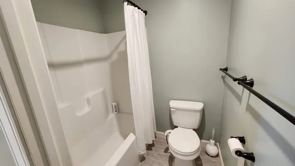 a bedroom with a bed tv and a window