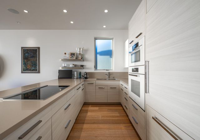 a kitchen with white cabinets sink and white appliances
