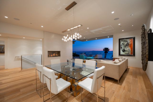 a view of a dining room with furniture a chandelier and wooden floor