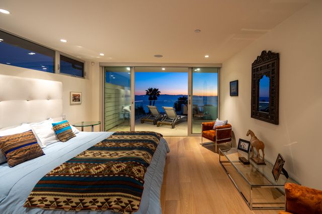 a bedroom with furniture and a rug