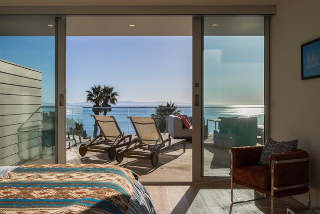 a bed room with a bed and glass window