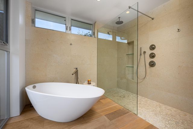 a bathroom with a bathtub and shower