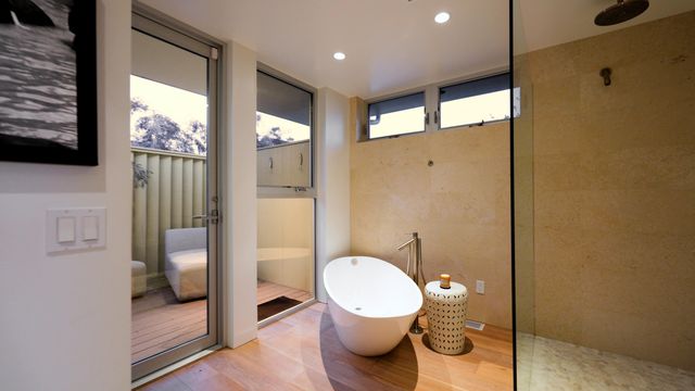 a bathroom with a toilet and a shower