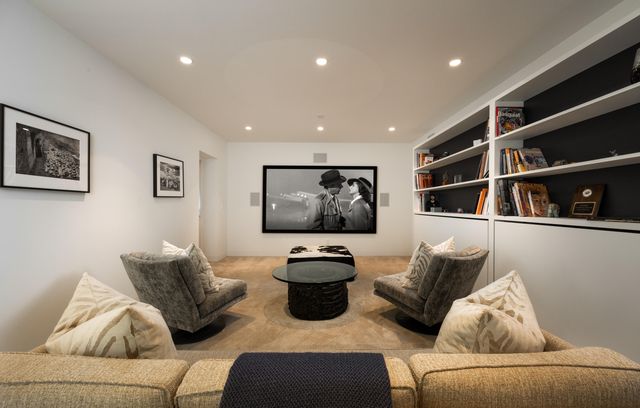 a living room with furniture and wall painting