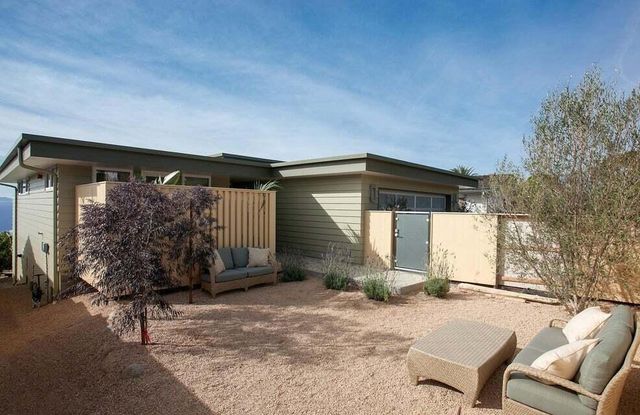 a backyard of a house with yard and glass windows