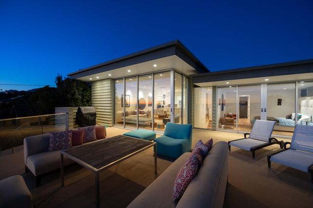 a living room with furniture and a floor to ceiling window