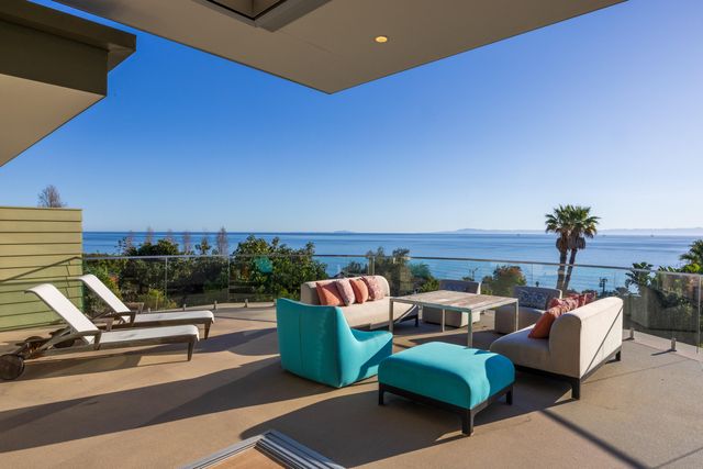 a terrace of a house with outdoor seating