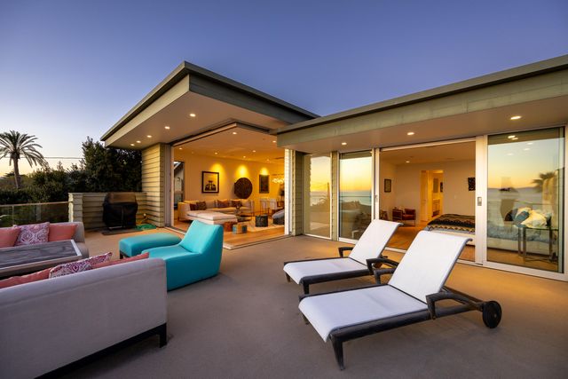 a view of a patio with couches and pool