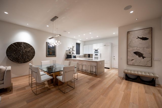 a living room with furniture and kitchen view
