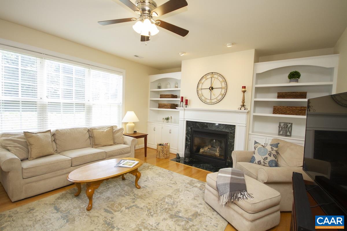 1380 Amber Ridge Road Charlottesville, VA 22901 - Photo 13 of 35 a living room with furniture a fireplace and a large window