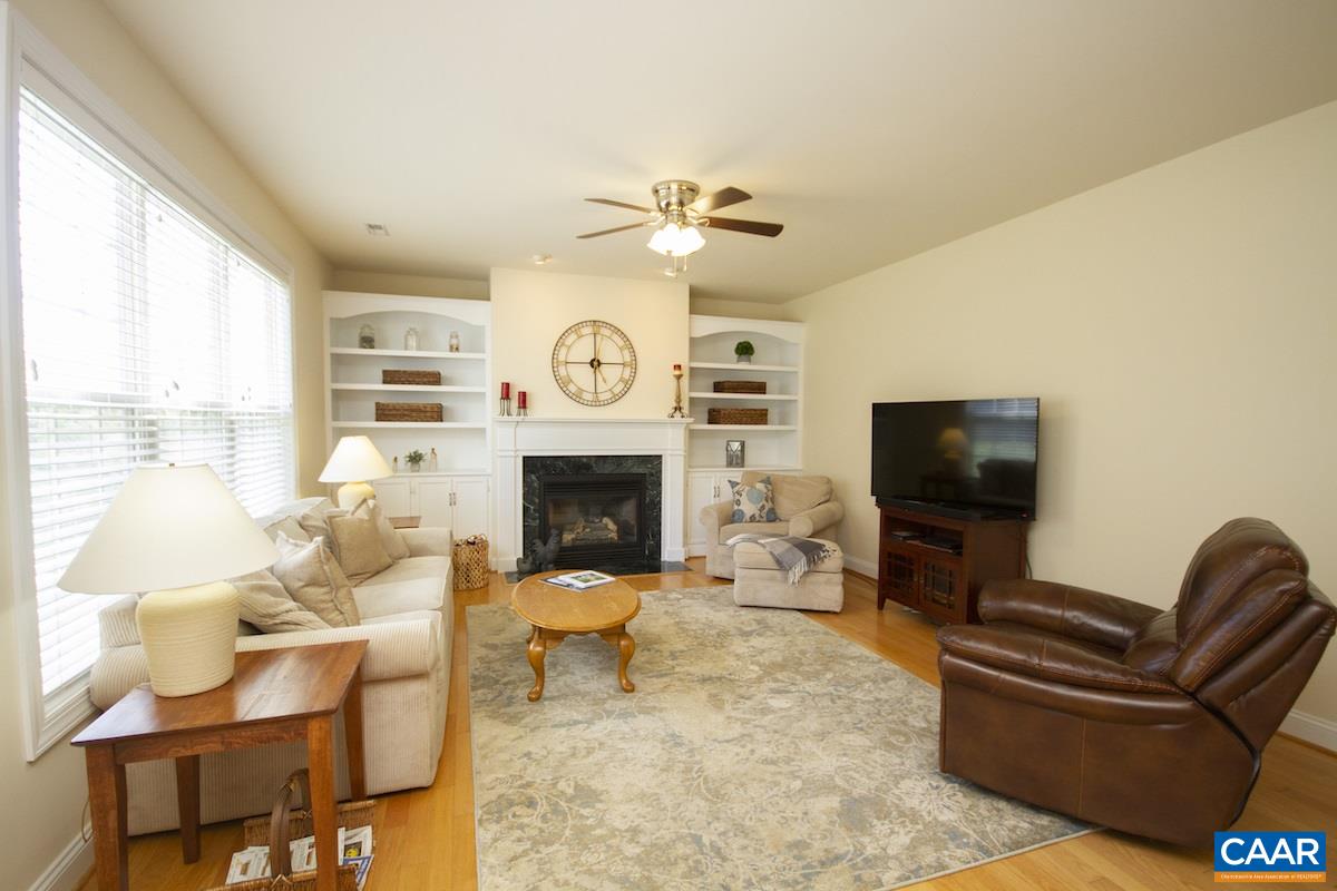 1380 Amber Ridge Road Charlottesville, VA 22901 - Photo 14 of 35 a living room with furniture a flat screen tv and a fireplace