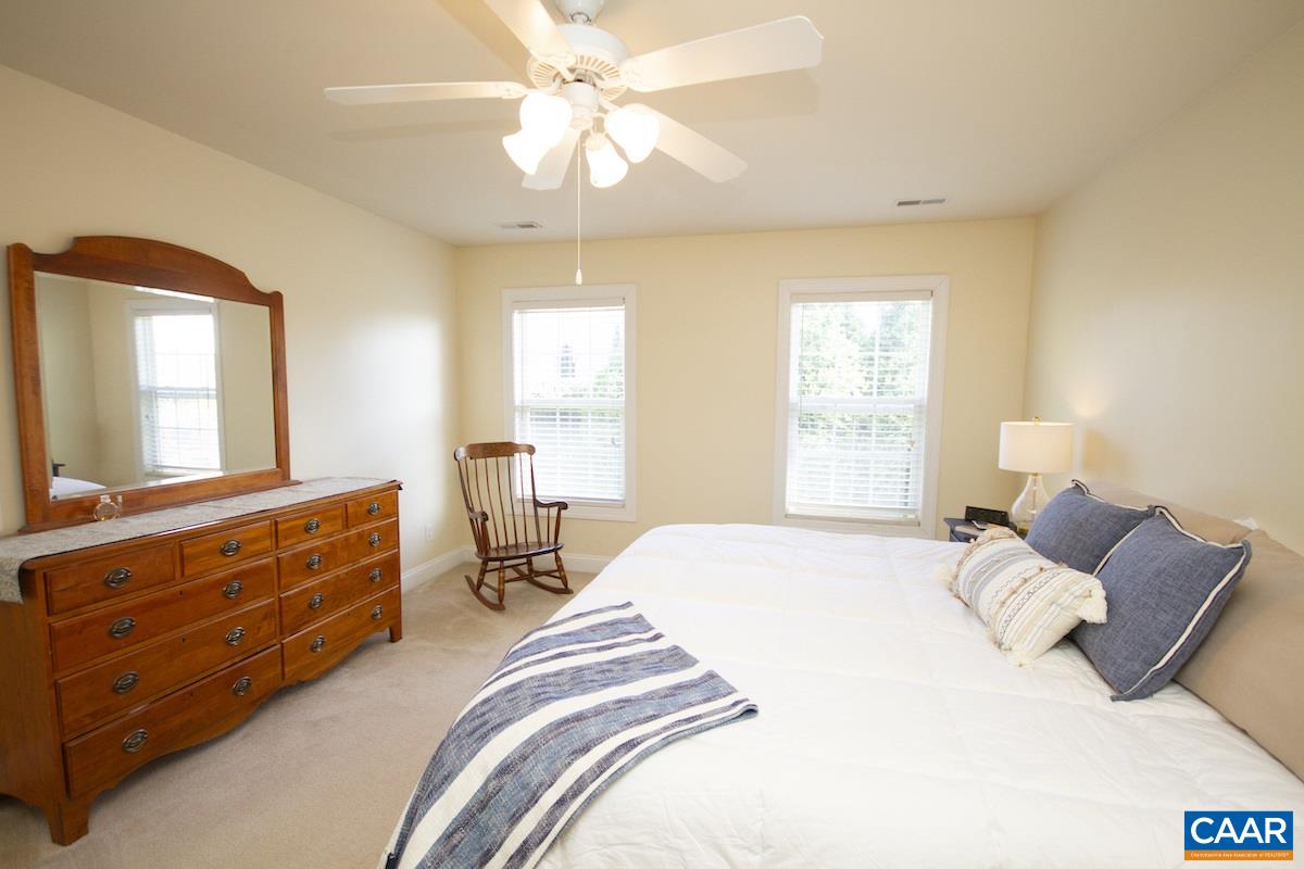 1380 Amber Ridge Road Charlottesville, VA 22901 - Photo 16 of 35 a bedroom with a bed and a chandelier