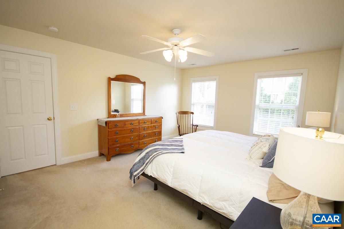 1380 Amber Ridge Road Charlottesville, VA 22901 - Photo 18 of 35 a bedroom with a bed and a chandelier