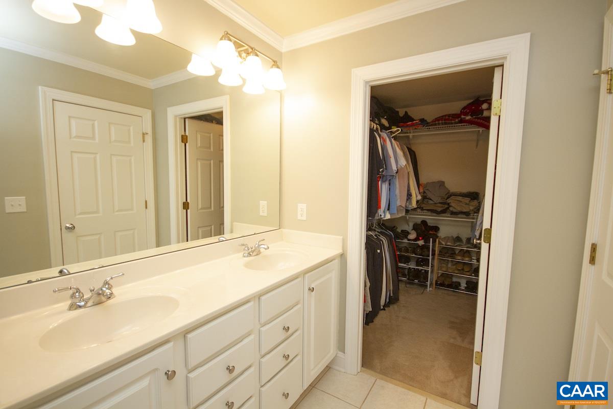 1380 Amber Ridge Road Charlottesville, VA 22901 - Photo 19 of 35 a en suite bathroom with a double vanity sink and a mirror