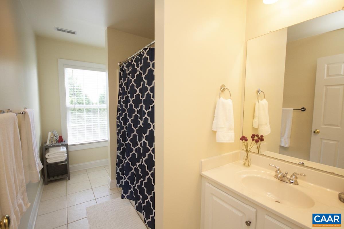 1380 Amber Ridge Road Charlottesville, VA 22901 - Photo 23 of 35 a bathroom with a sink a toilet and a mirror