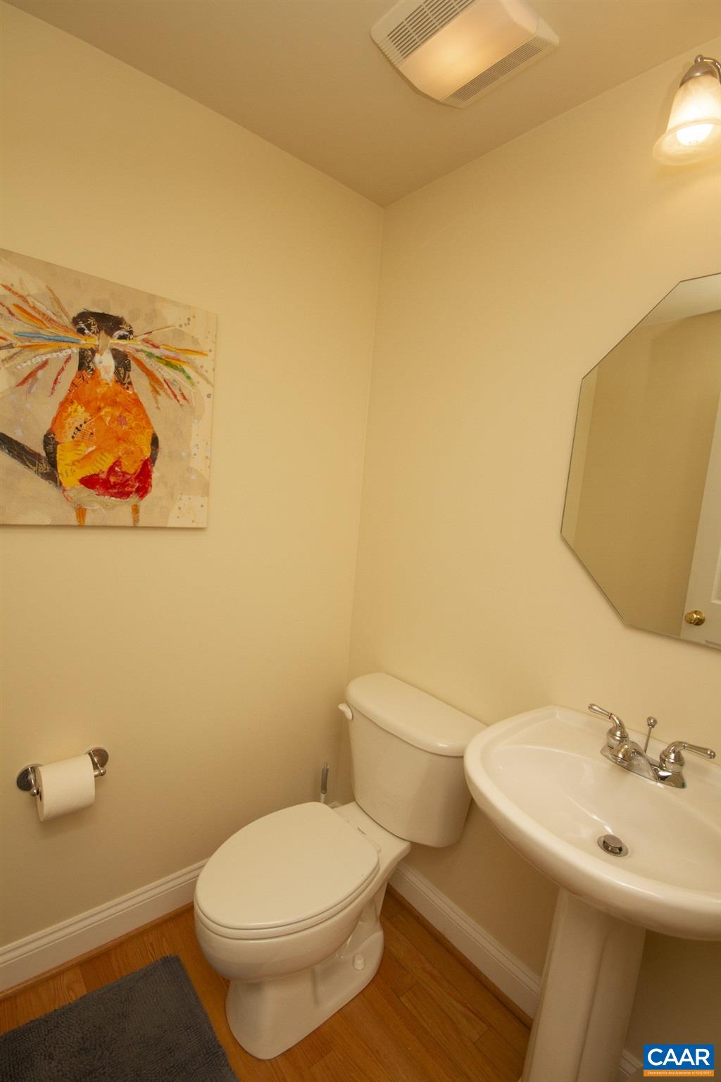 1380 Amber Ridge Road Charlottesville, VA 22901 - Photo 8 of 35 a white toilet sitting next to a bathroom sink and vanity