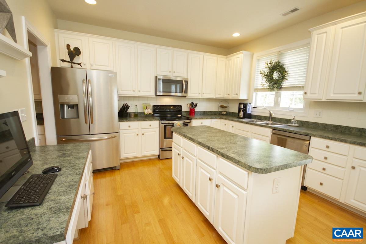 1380 Amber Ridge Road Charlottesville, VA 22901 - Photo 10 of 35 a kitchen with stainless steel appliances granite countertop a sink a stove top oven a refrigerator a counter top space and cabinets