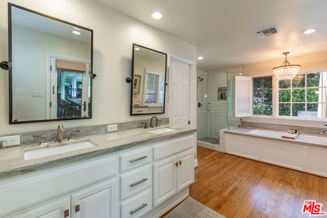 875 Hugo Reid Drive Arcadia, CA 91007 - Photo 22 of 53 a bathroom with a granite countertop sink mirror and bathtub