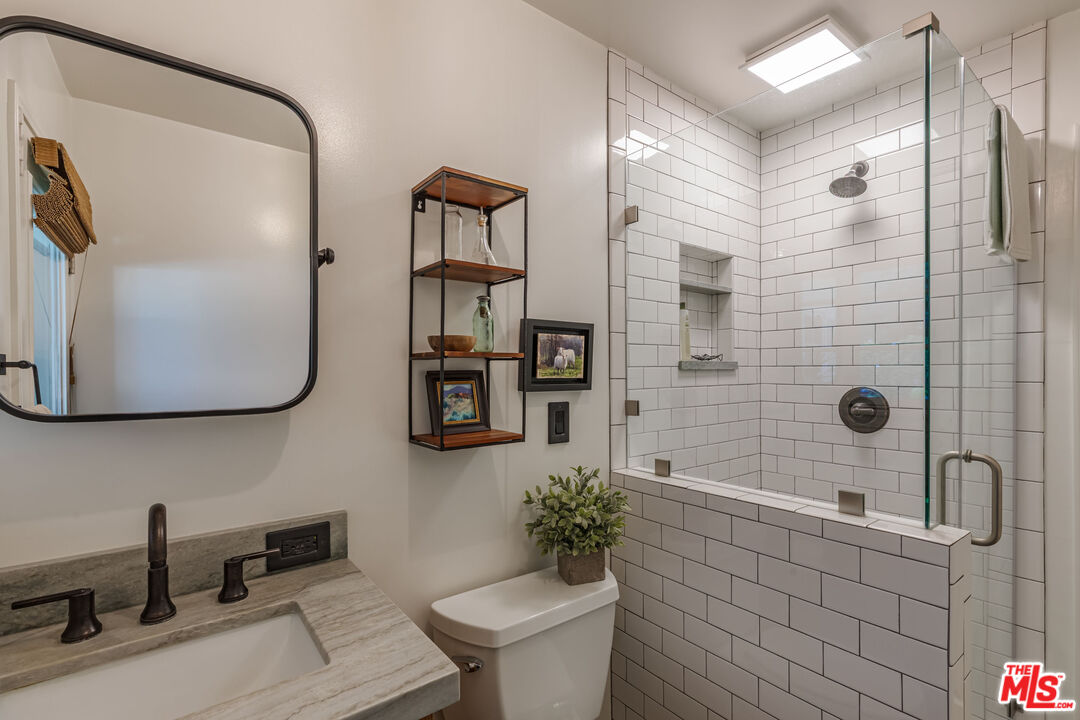875 Hugo Reid Drive Arcadia, CA 91007 - Photo 25 of 53 a bathroom with a granite countertop sink a toilet and shower